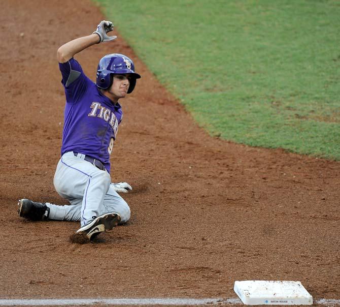 LSU freshman outfielder Mark Laird (9) slides into third base June 8, 2013 during the Tigers' 11-1 win against Oklahoma in Alex Box Stadium.
 