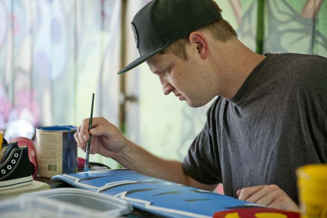 Marc Verret, also known as Marc Fresh, puts finishing touches on a painting in his outdoor workstation Monday, June 10, 2013 at his home in East Baton Rouge Parish.
 