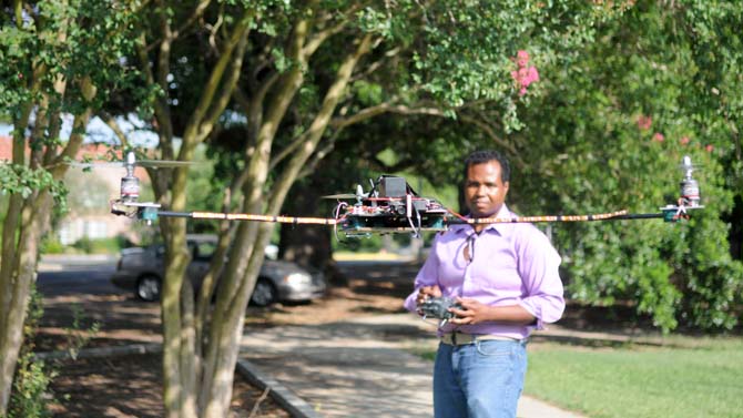 Biological and Agricultural engineering grad student Charles Malveaux pilots his hand-made tri-copter drone Sunday near the Agricultural and Biological engineering building.
 