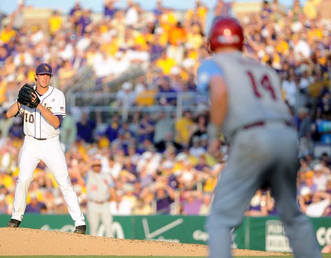 LSU sophomore pitcher Aaron Nola (10) eyes Oklahoma junior infielder Matt Oberste (14) June 7, 2013 during the Tigers' 2-0 win against the Sooners in Alex Box Stadium. Nola pitched all nine innings in the shutout.
 