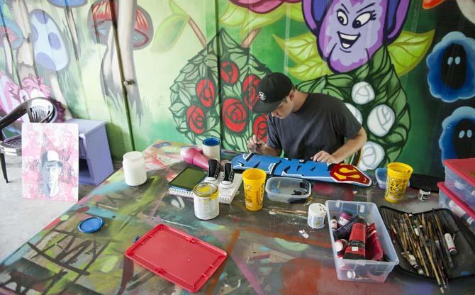 Marc Verret, also known as Marc Fresh, puts finishing touches on a painting in his outdoor workstation Monday, June 10, 2013 at his home in East Baton Rouge Parish.
 