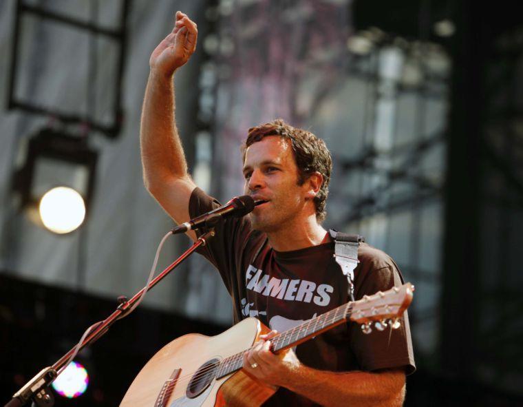 FILE - This Sept. 22, 2012 file photo shows Jack Johnson performing during the Farm Aid 2012 concert at Hersheypark Stadium in Hershey, Pa. Johnson has agreed to take the Saturday night headlining slot at the Bonnaroo Music &amp; Arts Festival after Mumford &amp; Sons were forced to cancel due to bassist Ted Dwane's illness. Festival officials announced the move Friday morning. The "Upside Down" singer last headlined at Bonnaroo in 2008. (AP Photo/Jacqueline Larma, file)
 