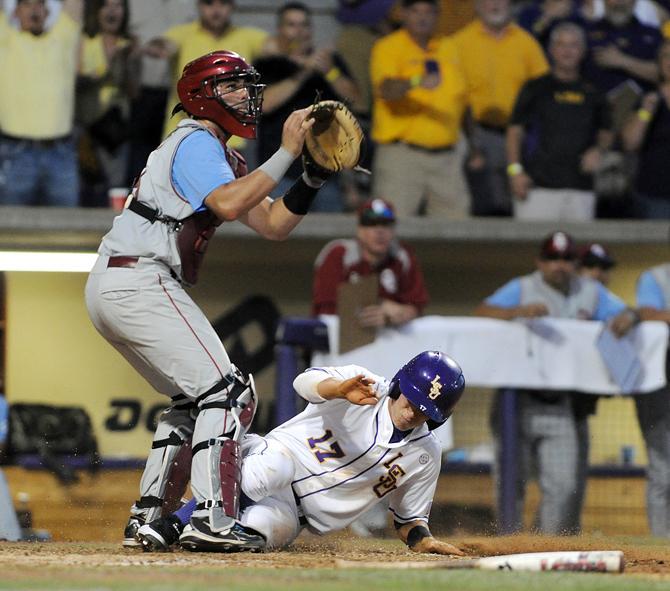 LSU sophomore infielder Jared Foster (17) slides into home June 7, 2013 during the Tigers' 2-0 win against Oklahoma in Alex Box Stadium.
 