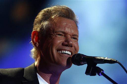 FILE - In this June 7, 2013 file photo, Randy Travis performs on day 2 of the 2013 CMA Music festival at the LP Field in Nashville, Tenn. Publicist Kirt Webster on Wednesday night, July 10, 2013 said that the 54-year-old Travis is in surgery after suffering a stroke while he was being treated for congestive heart failure because of a viral illness. (Photo by Wade Payne/Invision/AP, File)