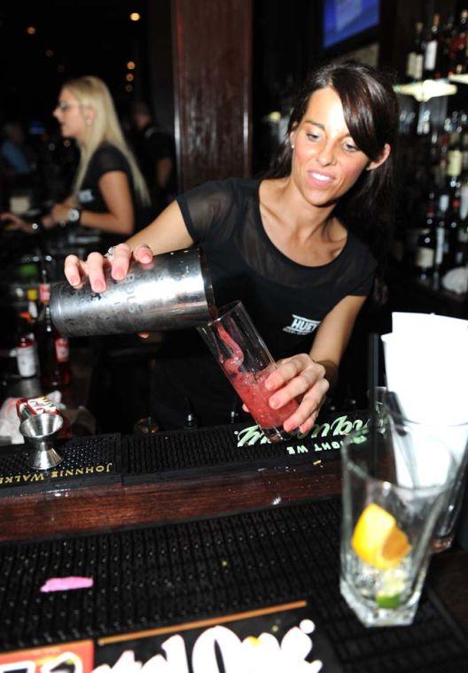 A bartender prepares a cocktail for a customer Friday, July 12, 2013 at Huey's, a new bar in downtown Baton Rouge.