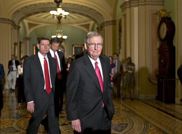 Senate Minority Leader Mitch McConnell of Ky., and GOP leaders arrive for a news conference on Capitol Hill in Washington, Tuesday, June 25, 2013, following a Republican strategy session. From left are, Sen. John Barrasso, R-Wyo., Sen, John Thune, R-S.D, and McConnell. (AP Photo/J. Scott Applewhite)