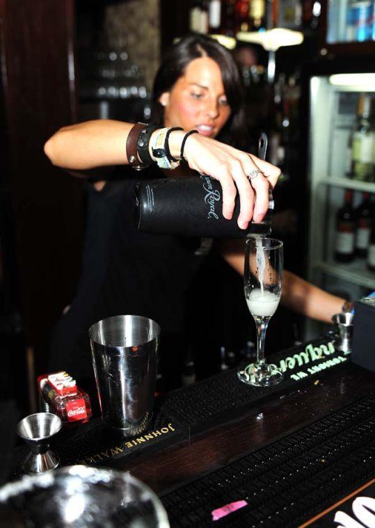 A bartender prepares a cocktail for a customer Friday, July 12, 2013 at Huey's, a new bar in downtown Baton Rouge.