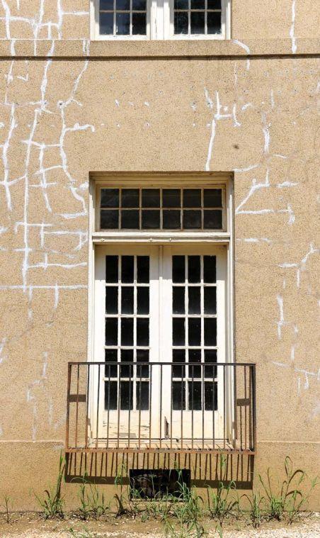 Cracks crawl along the face of the Old President's House Monday, July 8, 2013 near the Student Union.