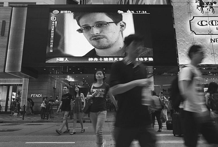 FILE - This June 23, 2013 file photo shows a TV screen shows a news report of Edward Snowden, a former CIA employee who leaked top-secret documents about sweeping U.S. surveillance programs, at a shopping mall in Hong Kong. President Barack Obama brushed aside sharp European criticism on Monday, suggesting all nations spy on each other, as the French and Germans expressed outrage over alleged U.S. eavesdropping on European Union diplomats. American analyst-turned-leaker Edward Snowden, believed to be stranded for the past week at Moscow&#8217;s international airport, applied for political asylum to remain in Russia. (AP Photo/Vincent Yu, File)