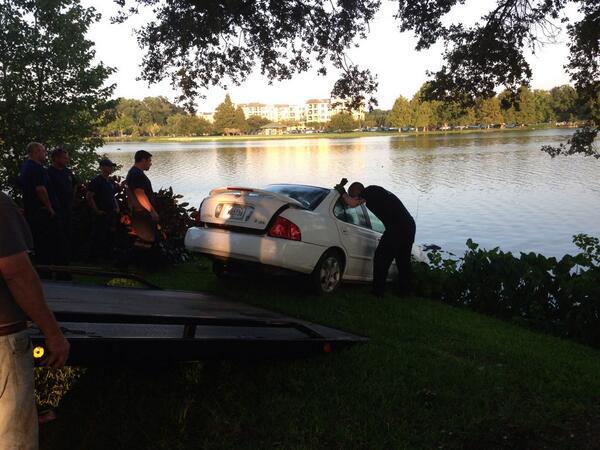 Police pull a car from the University Lake Tuesday after it flipped into the lake.&#160;