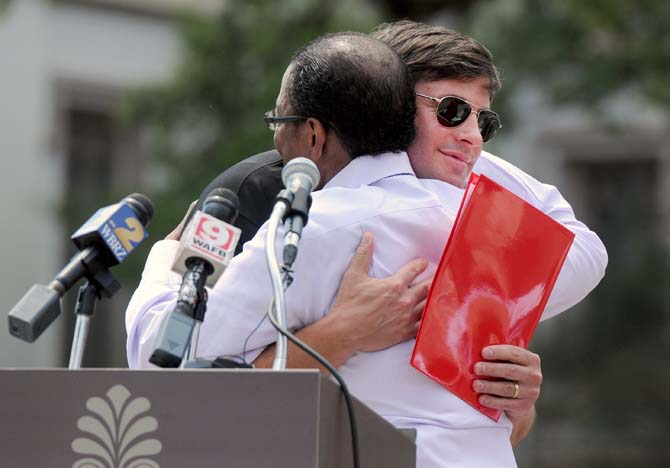 Raising Cane's Chicken Fingers founder and CEO Todd Graves (left) hugs Baton Rouge Mayor-President Kip Holden (right) on August 28, 2013, at the Red Stick Revelry news conference in Town Square.