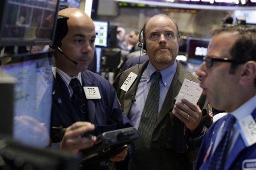 Trader Andrew O'Connor, center, works on the floor of the New York Stock Exchange, Tuesday, Aug. 27, 2013. Worries about a potential military strike against Syria are dragging down the U.S. stock market in early trading. (AP Photo/Richard Drew)