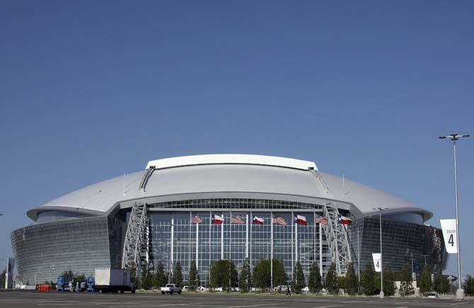 FILE - In this Aug. 19, 2009, file photo, the Dallas Cowboys new football stadium Cowboys Stadium is shown in Arlington, Texas. A person familiar with the decision tells The Associated Press that Arlington, Texas, has beaten out Tampa, Fla., in the bidding to be the site of the first title game in the new playoff system. The game will be Jan. 12, 2015. (AP Photo/Donna McWilliam, File) (The Associated Press)