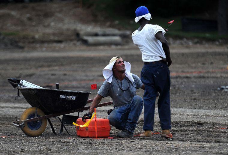 Construction workers discuss plans Thursday, Aug. 22, 2013, at the site of the new Cypress Residential Hall in Hart Lot.