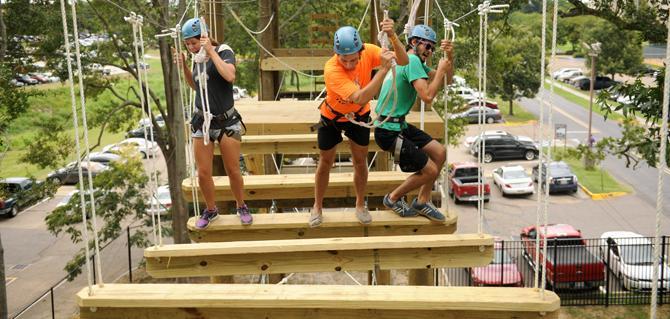 LSU kinesiology senior Hailey Guerin (right), geology-professional junior Tyler Hebert, and mechanical engineering senior Matt Greenwald work together to complete an obstacle Sunday, Aug. 25, 2013 at the UREC Challenge Course.