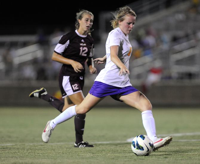 LSU freshman midfielder Emma Fletcher (8) kicks the ball past University of Louisiana-Monroe freshman defender Abigail Canny (12) Aug. 27, 2013 during the Tigers' 6-0 victory over the Warhawks at the LSU Soccer Stadium.