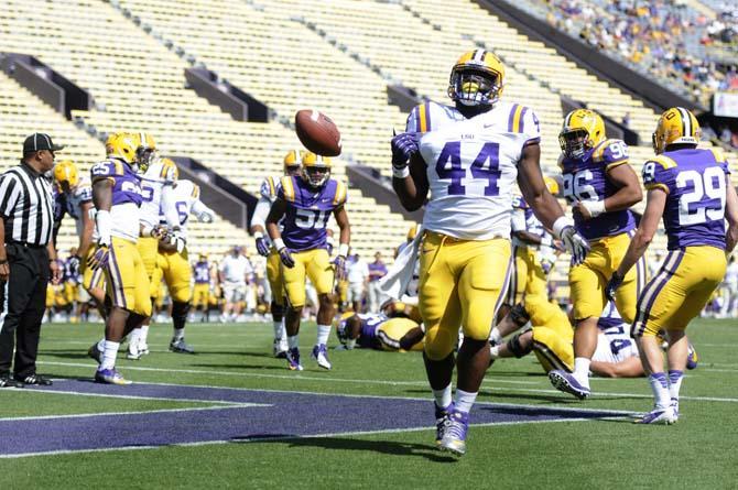 LSU senior fullback J.C. Copeland (44) drops the football Saturday, April 20, 2013 after scoring a touchdown for the white squad in the National L Club Spring Game in Tiger Stadium.