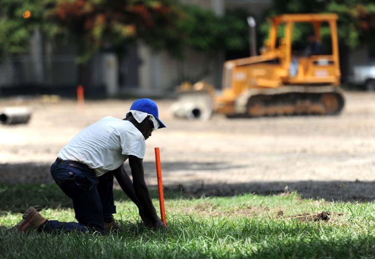 A construction worker stakes a spot Thursday, Aug. 22, 2013 at the site of the future Cypress Residential Hall in Hart Lot.