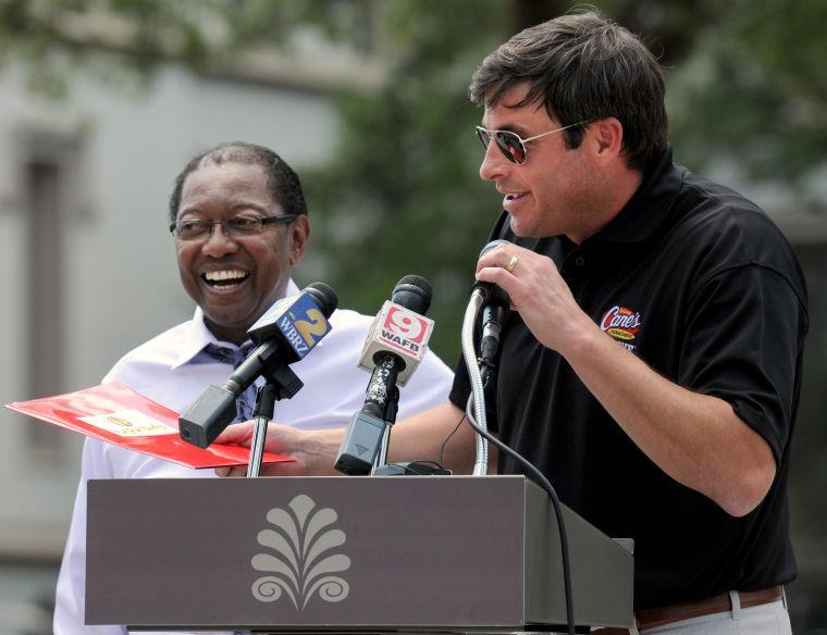 Raising Cane's Chicken Fingers founder and CEO Todd Graves (right) and Baton Rouge Mayor-President Kip Holden (left) share their excitement for the Red Stick Revelry event at a news conference in Town Square on August 28, 2013. Raising Cane's Chicken Fingers is one of the event sponsors.