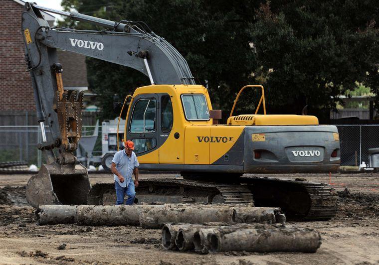 A worker exits a tractor Thursday, Aug. 22, 2013, at the construction site of Cypress Residential Hall in the Hart Lot.