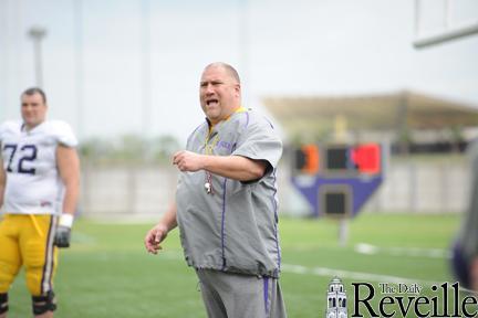 LSU football offensive coordinator Greg Studrawa directs the offensive linemen Tuesday at practice the LSU Football Practice Facility.