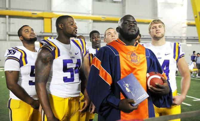 LSU junior defensive tackle Anthony Johnson (90) poses with his teammates Sunday, August 11, 2013 during LSU Football Media Day in the Charles McClendon Practice Facility.