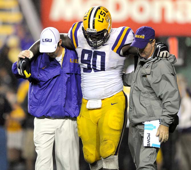 LSU junior defensive tackle Anthony Johnson (90) is helped off the field Saturday, Sept. 21, 2013, during the Tigers' 35-21 victory against Auburn in Tiger Stadium.