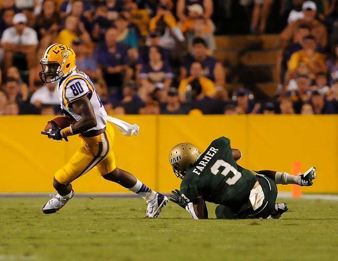 LSU junior wide reciever Jarvis Landry (80) escapes an attempted tackle by sophomore cornerback Lamarcus Farmer (3) Sept. 7, 2013 during the Tigers' 56-17 victory against the Blazers in Tiger Stadium.