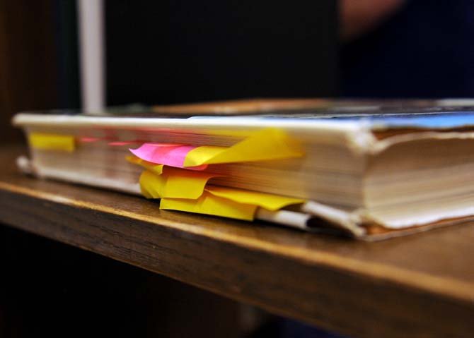 A damaged library book with sticky notes in it rests on a shelf Wednesday, September 25, 2013, in Middleton Library. A new campaign is being launched to prevent students from damaging books.