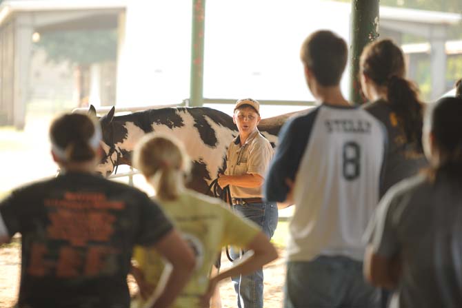 LSU Lab instructor, KC Annison, demonstrates the proper way to handle a horse Tuesday, Sept. 10, 2013 at BREC's Farr Park during the Horsemanship course offered to LSU students.