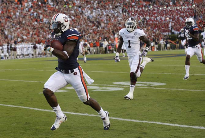 Auburn wide receiver Quan Bray (4) scores on a 61-yard touchdown reception as Mississippi State defensive back Nickoe Whitley (1) pursues during the first half of an NCAA college football game in Auburn, Ala., Saturday, Sept. 14, 2013. (AP Photo/Dave Martin)