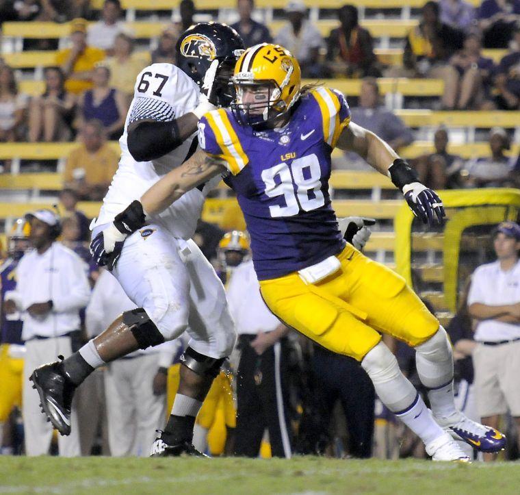 LSU junior defensive end Jordan Allen (98) pushes past Kent State junior offensive lineman Terrell Johnson (67) on Saturday night, Sept. 14, 2013 as the LSU faced Kent State.