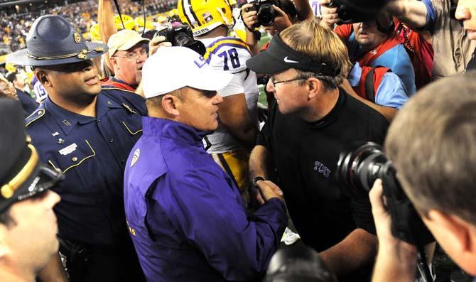 LSU head coach Les Miles and TCU head coach Gary Patterson shake hands after the Tigers' 37-27 victory against the Horned Frogs Saturday, August 31, 2013 in the 2013 Cowboys Classic at AT&amp;T Stadium in Arlington, Texas.