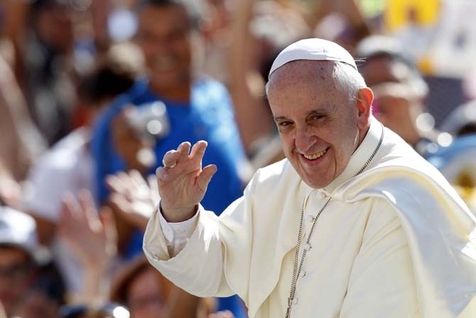 Pope Francis waves to faithful as he arrives for his weekly general audience in St. Peter's square at the Vatican, Wednesday, Sept. 4, 2013. (AP Photo/Riccardo De Luca)