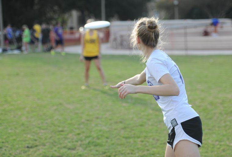 Haley Rowe-Kadow launches a frisbee toward another player Tuesday at the Parade Ground.