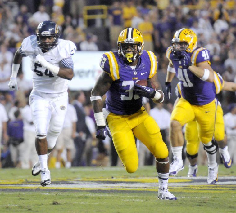 LSU sophomore running back Jeremy Hill (33) carries the ball down field Saturday night, Sept. 14, 2013, in the Tigers' 45-13 victory against Kent State.