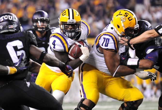 LSU senior running back Alfred Blue (4) maneuvers downfield Saturday, August 31, 2013 during the Tigers' 32-27 victory against TCU in the 2013 Cowboys Classic at AT&amp;T Stadium in Arlington, Texas.