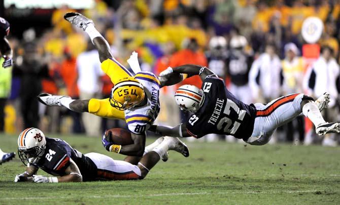 LSU junior wide receiver Jarvis Landry (80) is brought down by Auburn junior defensive back Robenson Therezie (27) Saturday, Sept. 21, 2013 during the Tigers' 35-21 victory against Auburn in Tiger Stadium.