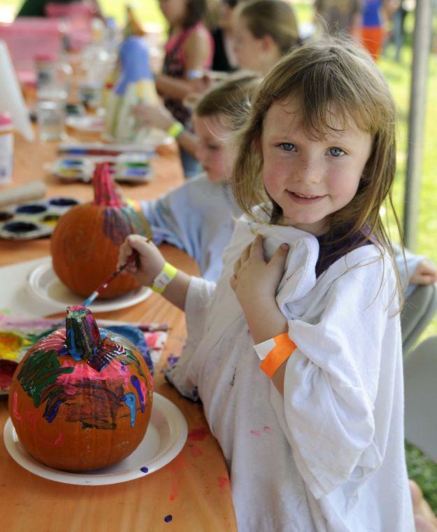 Madelyn Viger paints a pumpkin Saturday afternoon, Sept. 28, 2013 at the Corn Maze at LSU AgCenter Botanic Gardens at Burden.