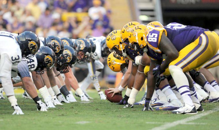 The Tigers crouch at the line of scrimmage Saturday night, Sept. 14, 2013 in Tiger Stadium.