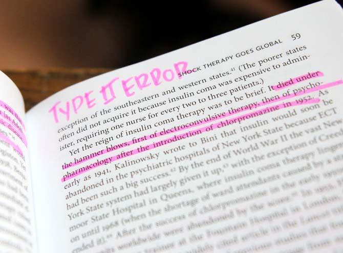 A damaged library book with highlighter marks in it rests on a shelf Wednesday, September 25, 2013, in Middleton Library. A new campaign is being launched to prevent students from damaging books.