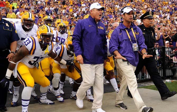 LSU head football coach Les Miles leads his team onto the field on Sept. 7, 2013 before the 56-17 victory against UAB in Tiger Stadium.