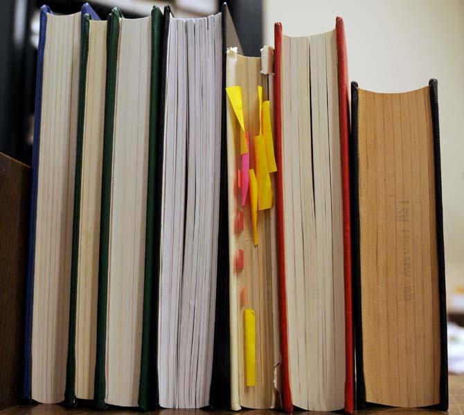 A damaged library book with sticky notes in it rests on a shelf Wednesday, September 25, 2013, in Middleton Library. A new campaign is being launched to prevent students from damaging books.