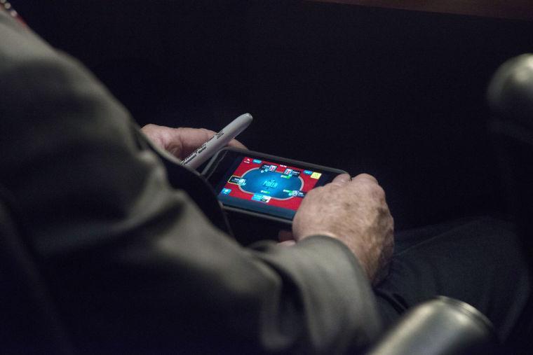 WASHINGTON, DC - SEPTEMBER 3: Senator John McCain plays poker on his IPhone during a U.S. Senate Committee on Foreign Relations hearing where Secretary of State John Kerry, Secretary of Defense Chuck Hagel, and Chairman of the Joint Chiefs of Staff General Martin Dempsey testify concerning the use of force in Syria, on Capitol Hill in Washington DC, Tuesday, September 3, 2013. (Photo by Melina Mara/The Washington Post)