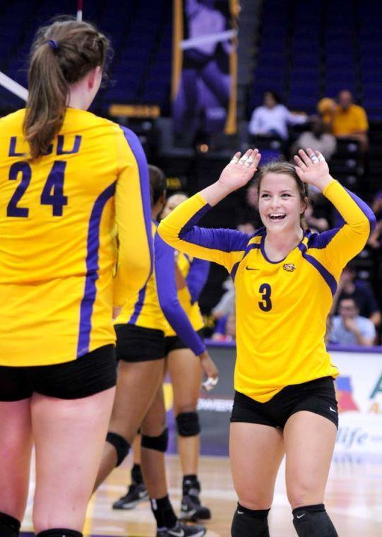 Sophomore, Cati Leak (24), along with Junior, Laura Whalen (3) high-five Friday Aug. 30, 2013 against their match set against Texas San-Antonio