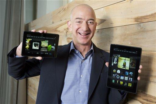 IMAGE DISTRIBUTED FOR AMAZON &#8211; In this image distributed on Tuesday, Sept. 24, 2013, Amazon.com Founder and CEO Jeff Bezos introduces the all-new Kindle Fire HDX 8.9'', right, and Kindle Fire HDX 7'' tablet in Seattle."