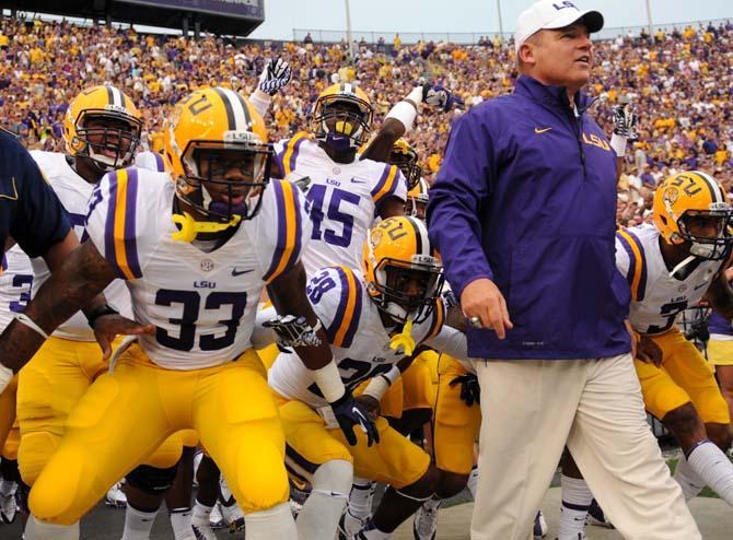 LSU head football coach Les Miles leads his team onto the field on Sept. 7, 2013 before the 56-17 victory against UAB in Tiger Stadium.