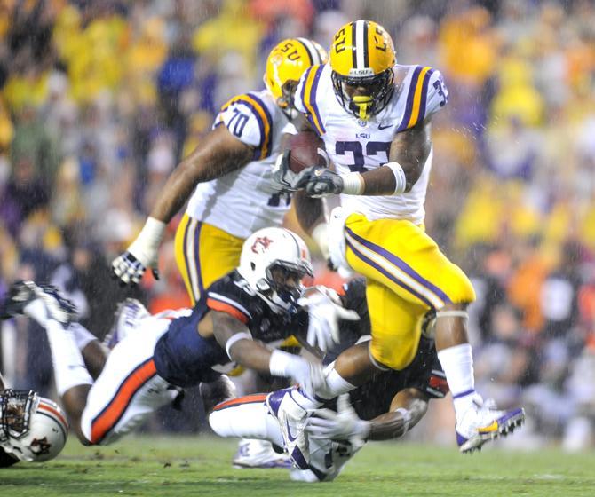 LSU sophomore running back Jeremy Hill (33) evades multiple defenders Saturday, Sept. 21, 2013 during the Tigers' matchup against Auburn in Tiger Stadium.