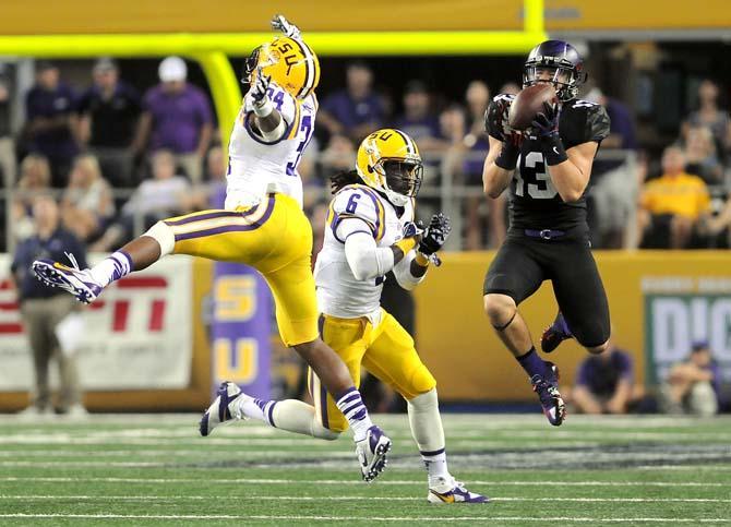 LSU senior safety Craig Loston (6) goes to tackle a TCU freshman wide receiver Ty Slanina (13) Saturday, August 31, 2013 during the Tigers' 32-27 victory against the Horned Frogs in the 2013 Cowboys Classic at AT&amp;T Stadium in Arlington, Texas.