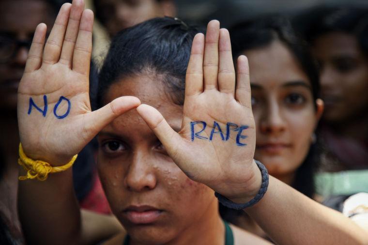 An Indian student displays "NO RAPE" message painted on her hands during a demonstration to demand death sentence for four men convicted of rape and murder of a student on a moving bus in New Delhi bus last year, in Hyderabad, India, Friday, Sept. 13, 2013. A judge on Friday ordered all four to the gallows for a brutal attack that left the young woman with such severe internal injuries that she died two weeks later. (AP Photo/Mahesh Kumar A.)